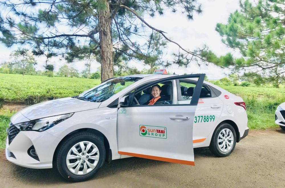 Xe taxi Sun màu vàng đặc trưng đậu trên đường phố sầm uất của Tam Kỳ